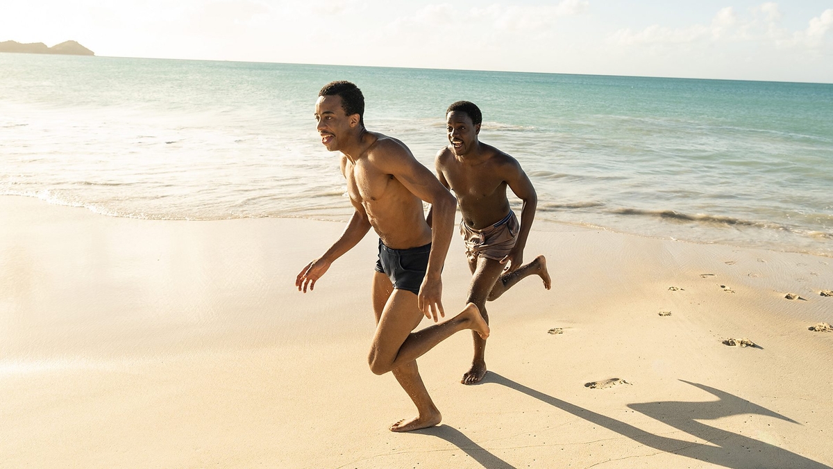 Keenan Munn Francis and Gabin Kongolo as young Barrington and young Morris run together on a beach