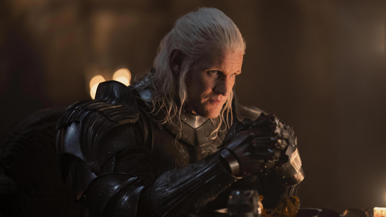 Daemon Targaryen sits in a suit of armour, frowning