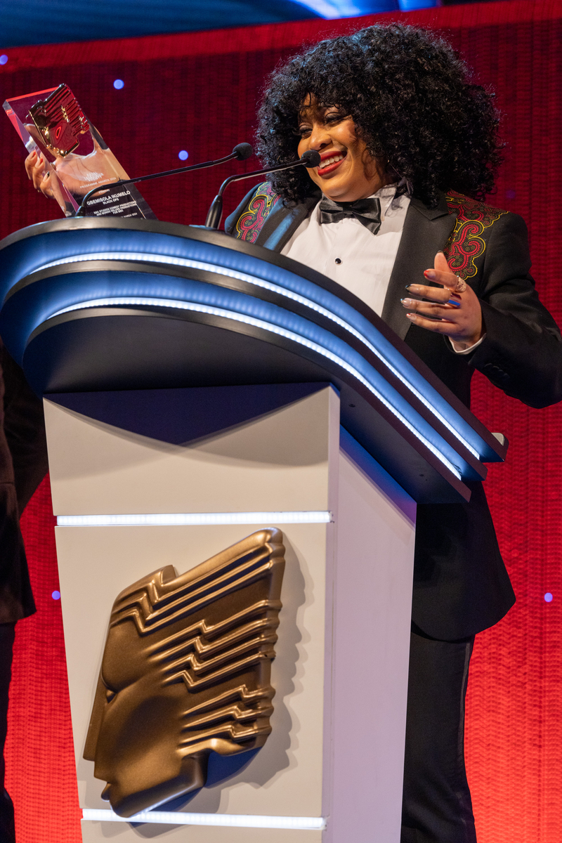 Gbemisola Ikumelo accepting an RTS Award onstage